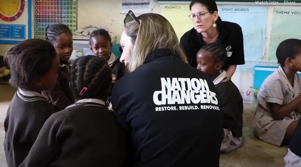 A Nation Changers reading coach with learners in a primary school classroom