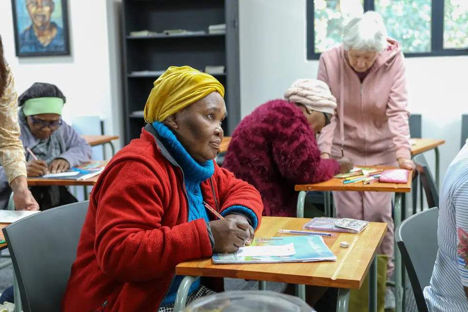 Adult literacy learners writing at the Nation Changers Centre